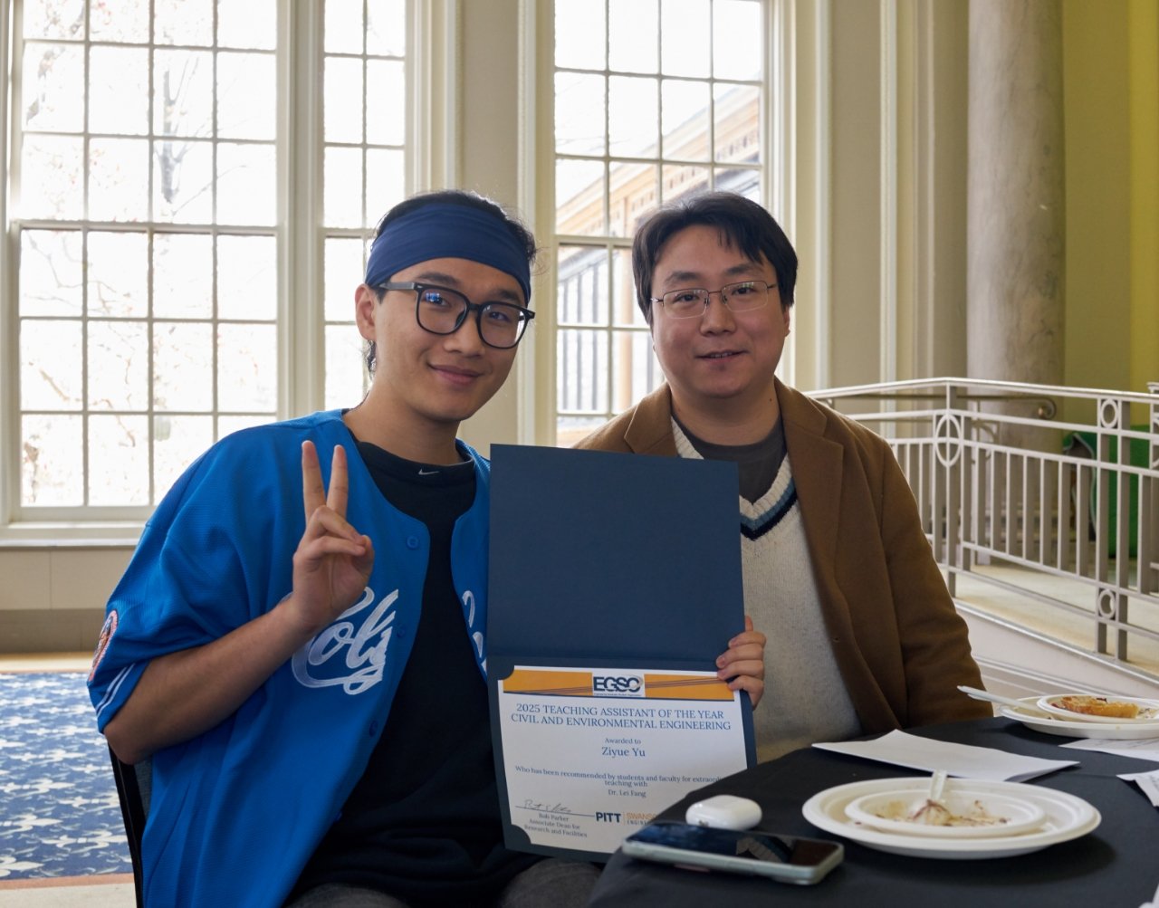 Ziyue Yu with advisor Prof. Lei Fang, holding the 2025 Teaching Assistant of the Year award